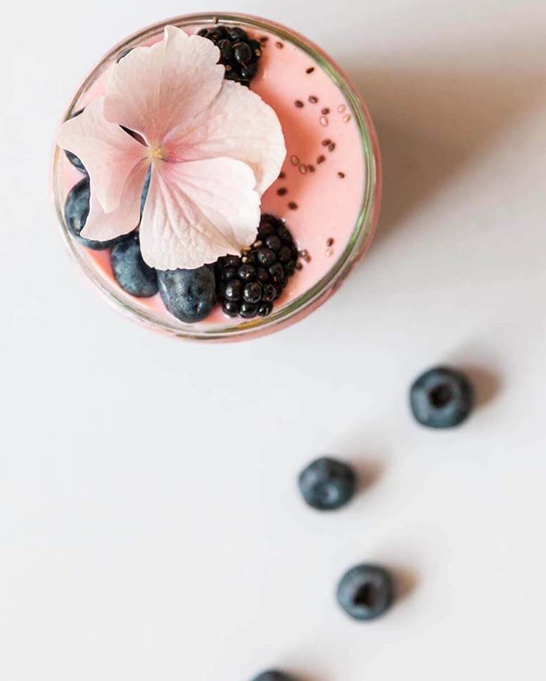 A fruit smoothie with bluberries.