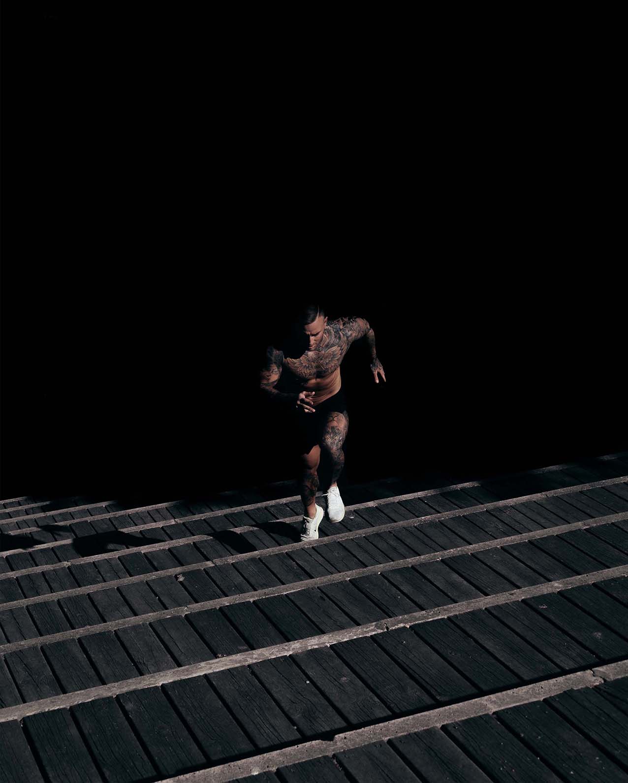 A man runs up stadium stairs.